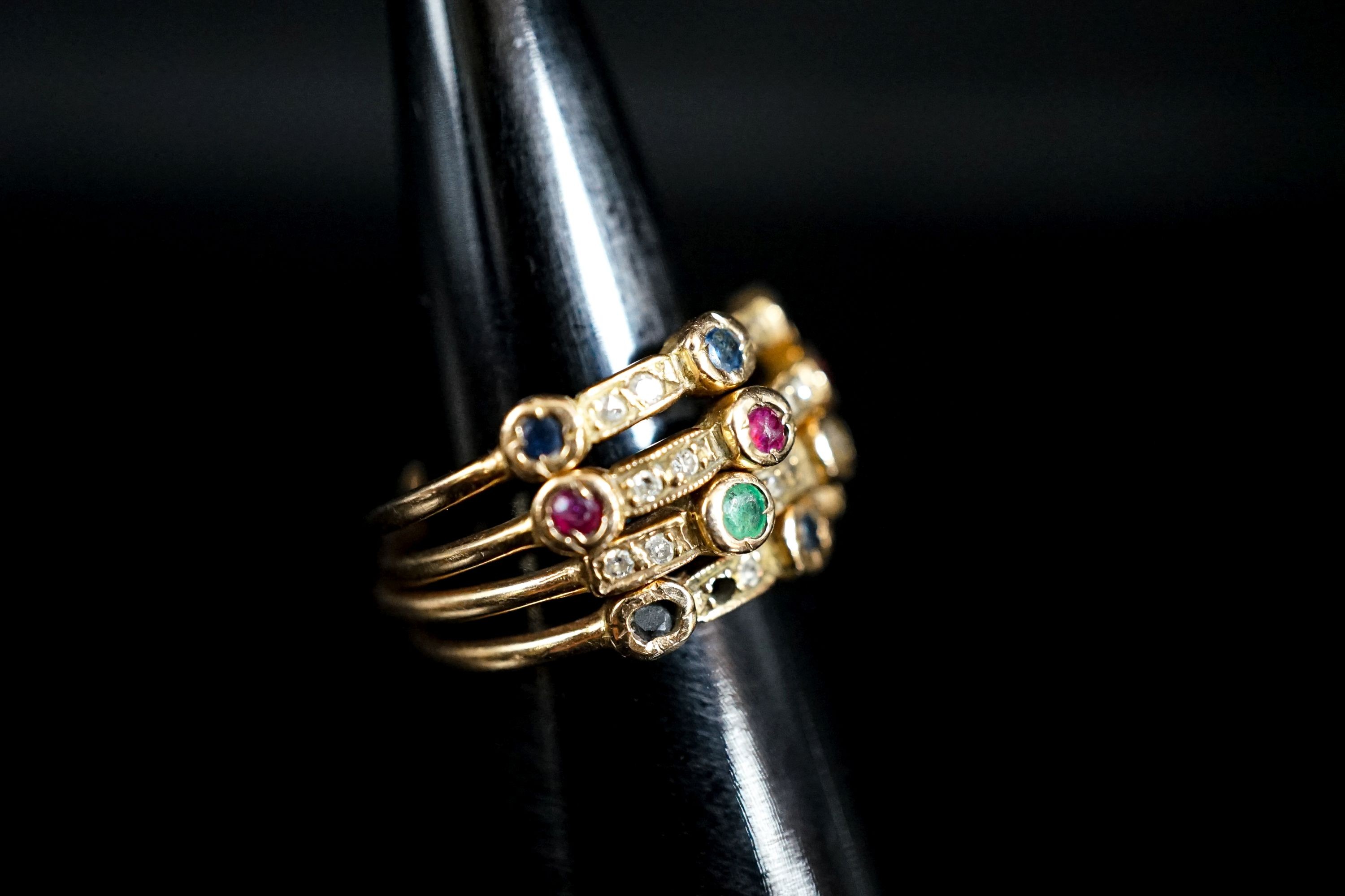 A yellow metal yellow metal and multi gem set quadruple shank dress ring, size M/N, gross weight 5.8 grams(two stones missing).